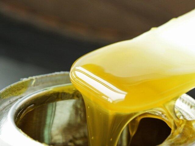 Close-up of contact adhesive being applied from an open container for strong multi-surface bonding