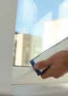 Smoothing sealant along a window frame