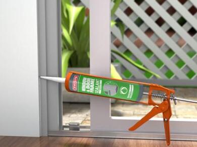 Applying EVO-STIK Window and Door Frame Sealant around a sliding door frame to create a weatherproof seal