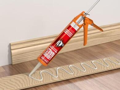 Applying EVO-STIK Liquid Nails Interior Adhesive in a zigzag pattern to the back of a skirting board before installation