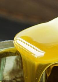 Close-up of contact adhesive being applied from an open container for strong multi-surface bonding